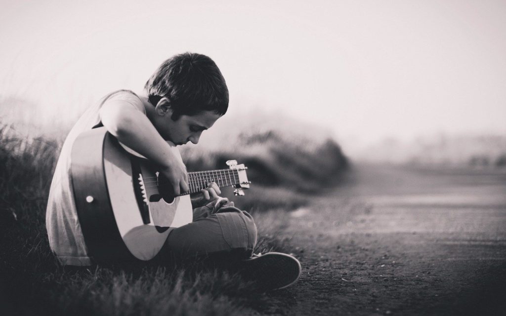 Boy practicing a guitar